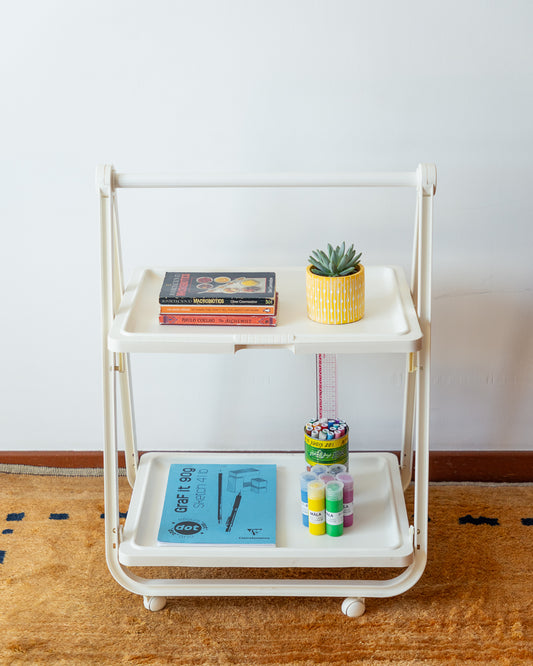 SIMO Italian folding plastic cart from the 1970s, vintage design with compact fold-flat system, versatile as a bar cart, side table, or storage unit. Excellent vintage condition with minor age-related signs. One-of-a-kind retro piece available at Vecino Shop.