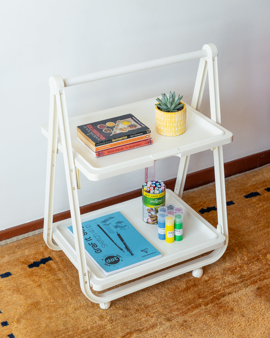 SIMO Italian folding plastic cart from the 1970s, vintage design with compact fold-flat system, versatile as a bar cart, side table, or storage unit. Excellent vintage condition with minor age-related signs. One-of-a-kind retro piece available at Vecino Shop.