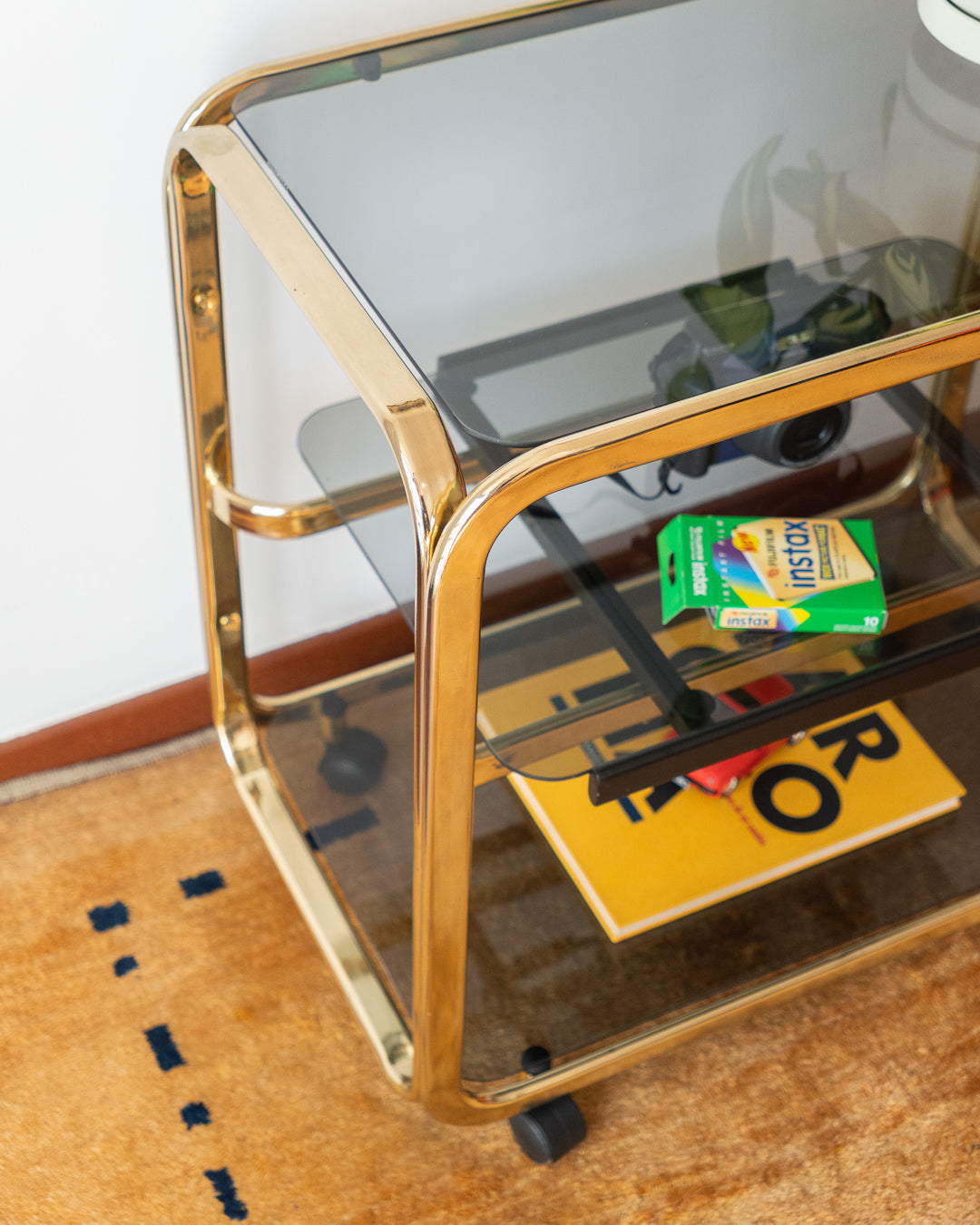 Vintage 1970s gold and smoked glass 3-tier side table, middle sliding shelf, wheels, polished and restored, very good condition | Vecino Shop