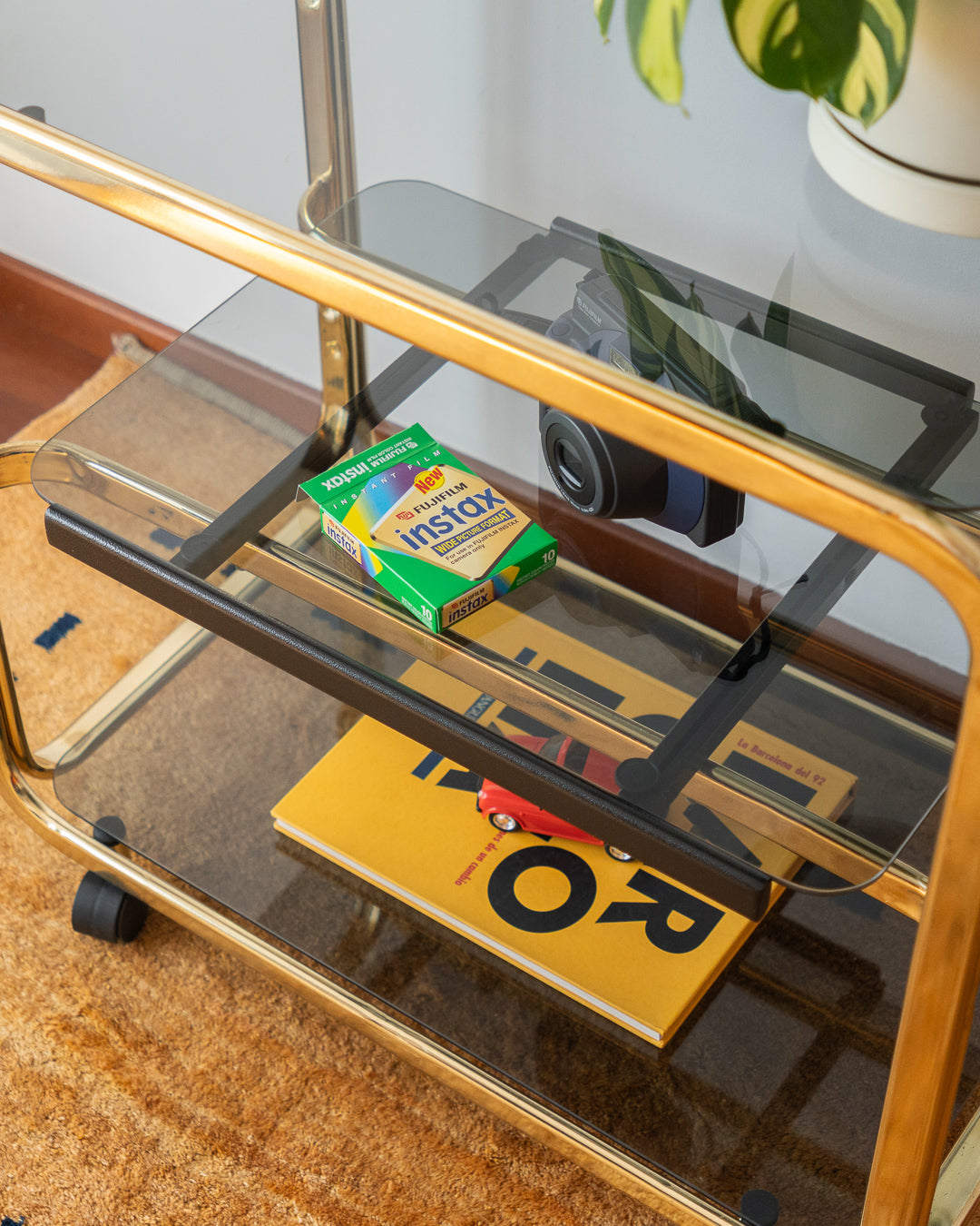 Vintage 1970s gold and smoked glass 3-tier side table, middle sliding shelf, wheels, polished and restored, very good condition | Vecino Shop