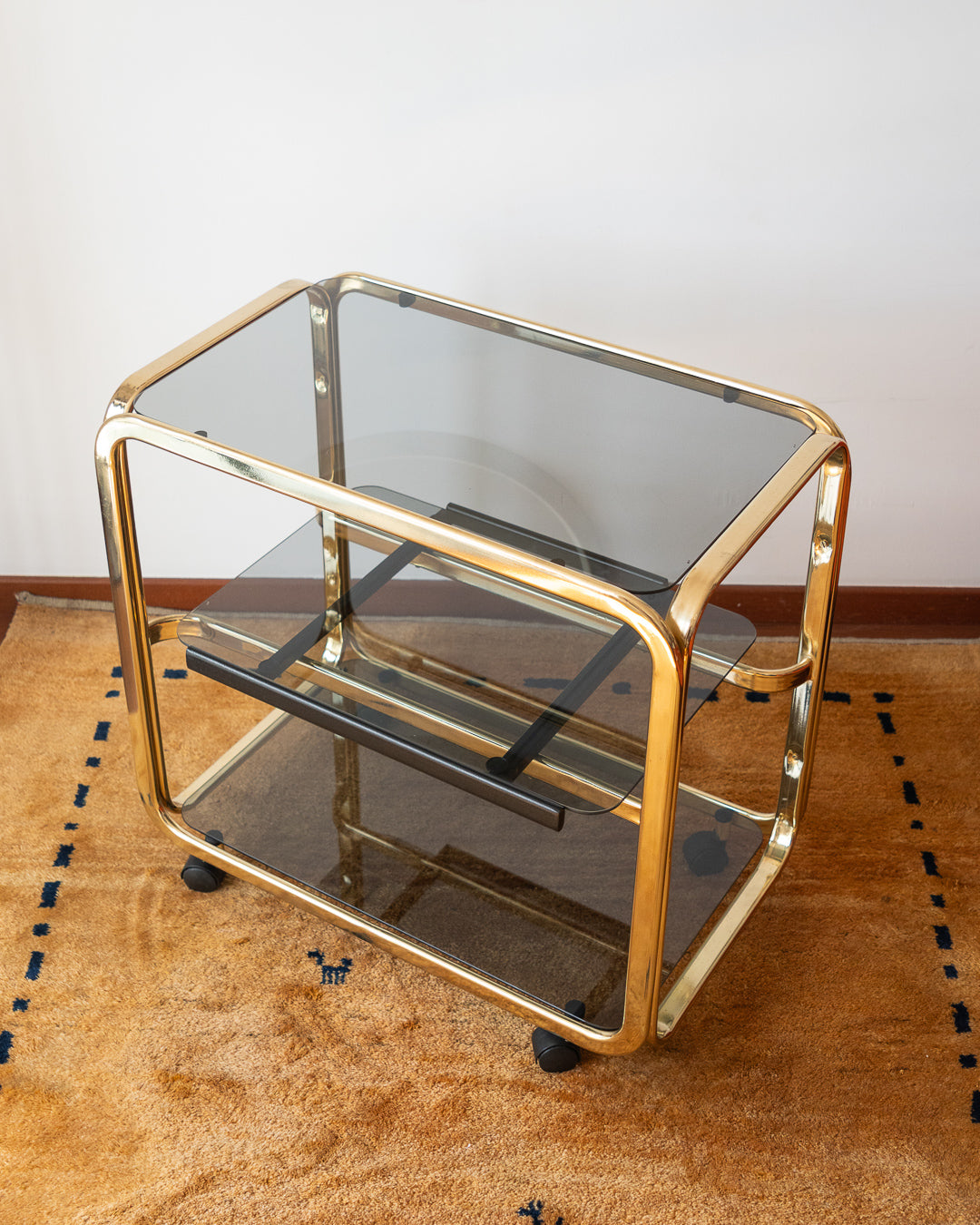 Vintage 1970s gold and smoked glass 3-tier side table, middle sliding shelf, wheels, polished and restored, very good condition | Vecino Shop