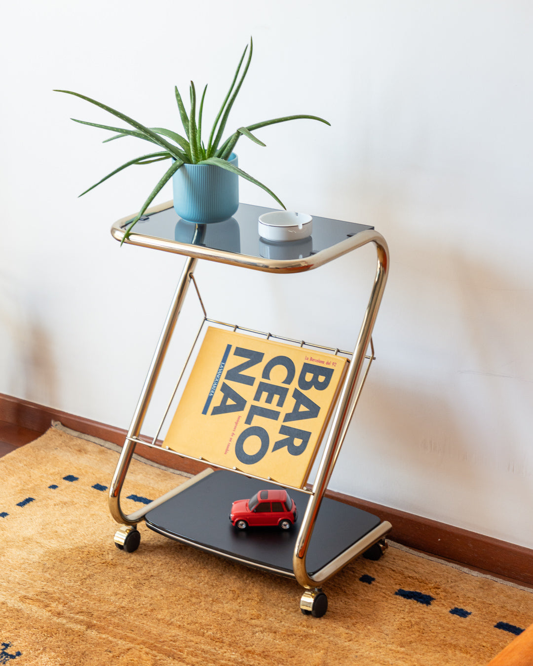 Vintage 80s rolling side table with golden frame, glass top and wood shelf – Vecino Shop