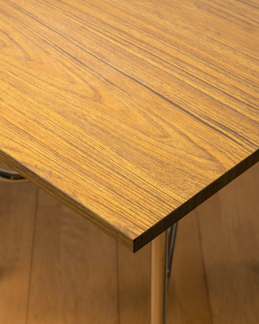 Vintage 1980s folding dining table with brown wood veneer Formica table top, chrome tubular legs and square corners. Space Age space-saving design. Vecino Shop