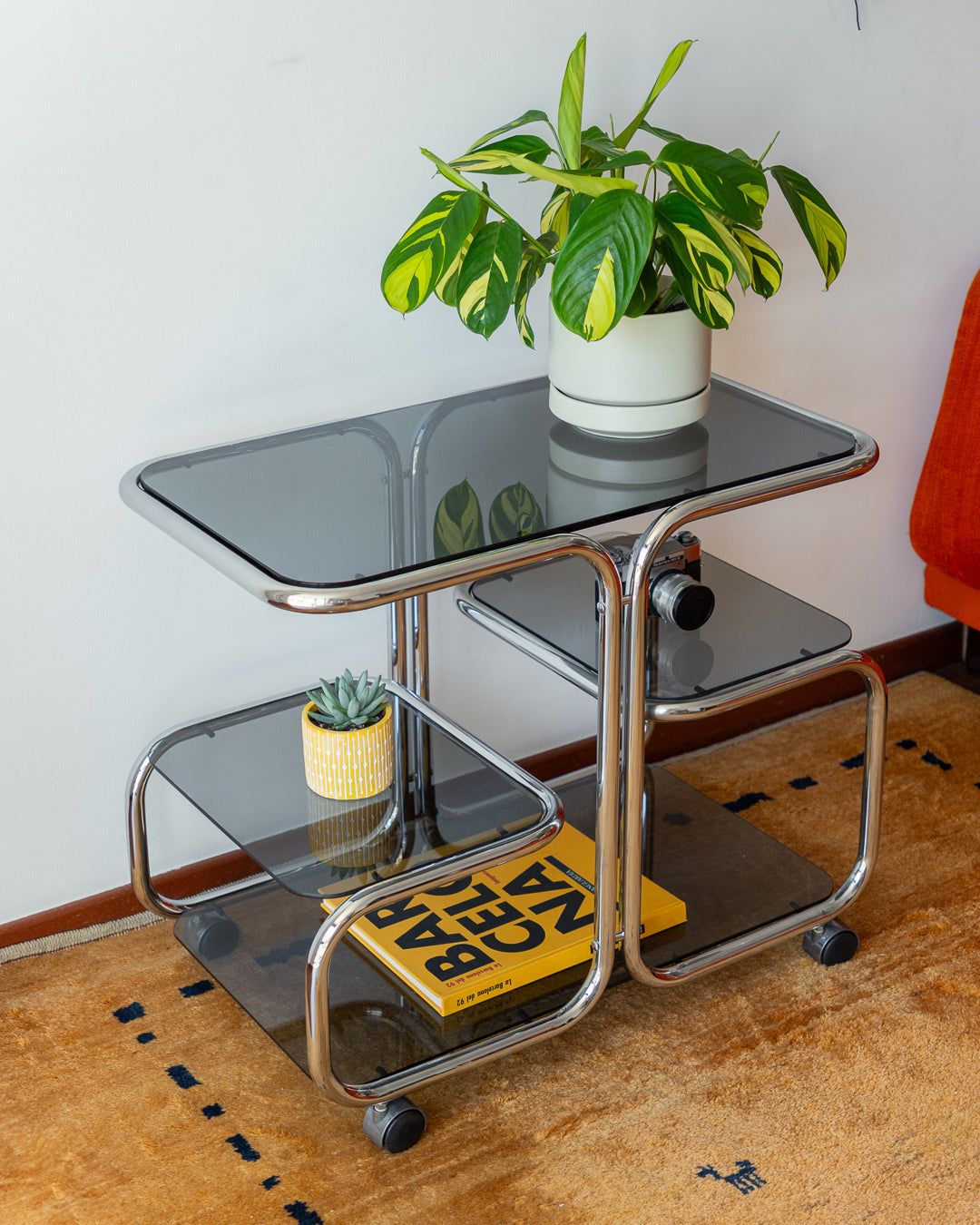Vintage chrome side table with 4 smoked glass tiers, 1970s, restored and polished, available at Vecino Shop, Barcelona, worldwide shipping.