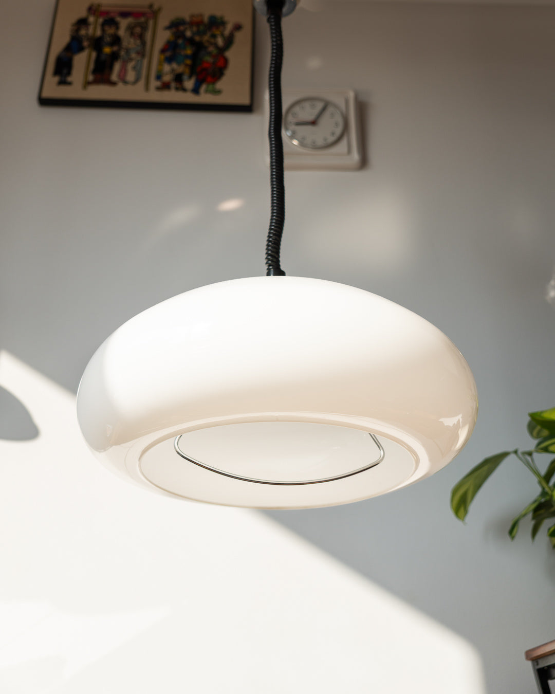 Retro 1960s/70s extendable Space Age ceiling lamp with white plastic shade, chrome accents, and black spiral cord. Sculptural, functional, and iconic.