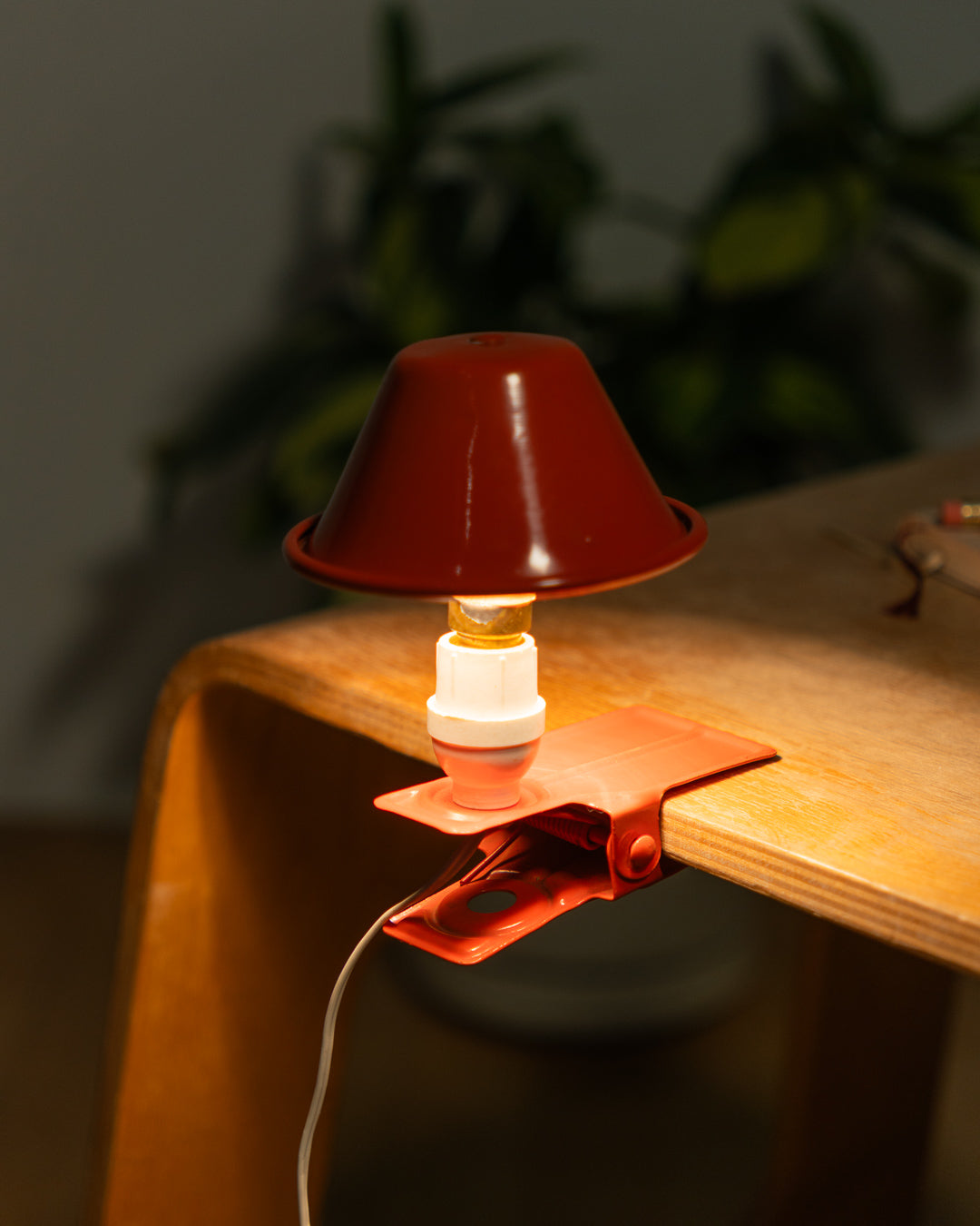 Vintage orange Luxus mushroom clip lamp from the 1970s with white housing and clamp base. Retro space age lighting piece.