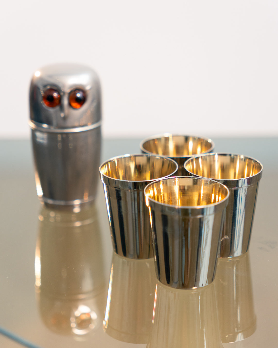 Vintage 1960s owl nesting shot glass set from West Germany with chrome body, amber eyes. Vecino Shop