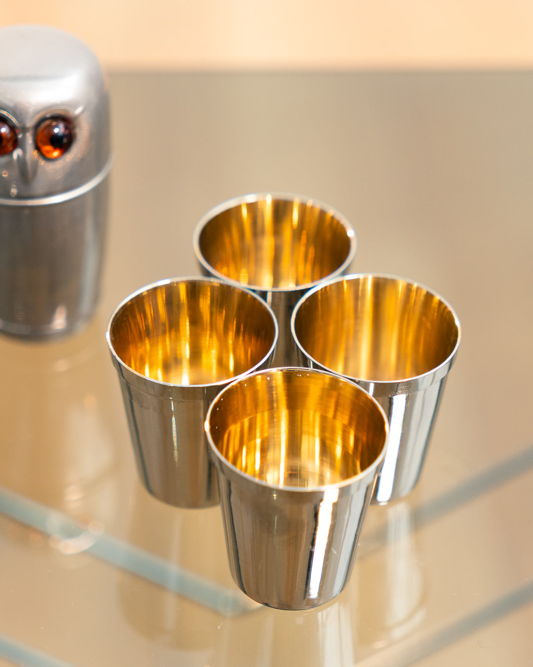 Vintage 1960s owl nesting shot glass set from West Germany with chrome body, amber eyes. Vecino Shop