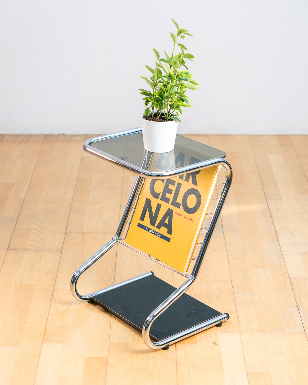 Vintage 1970s chrome side table with smoked glass top, black melamine shelf and integrated magazine rack. Vecino Shop