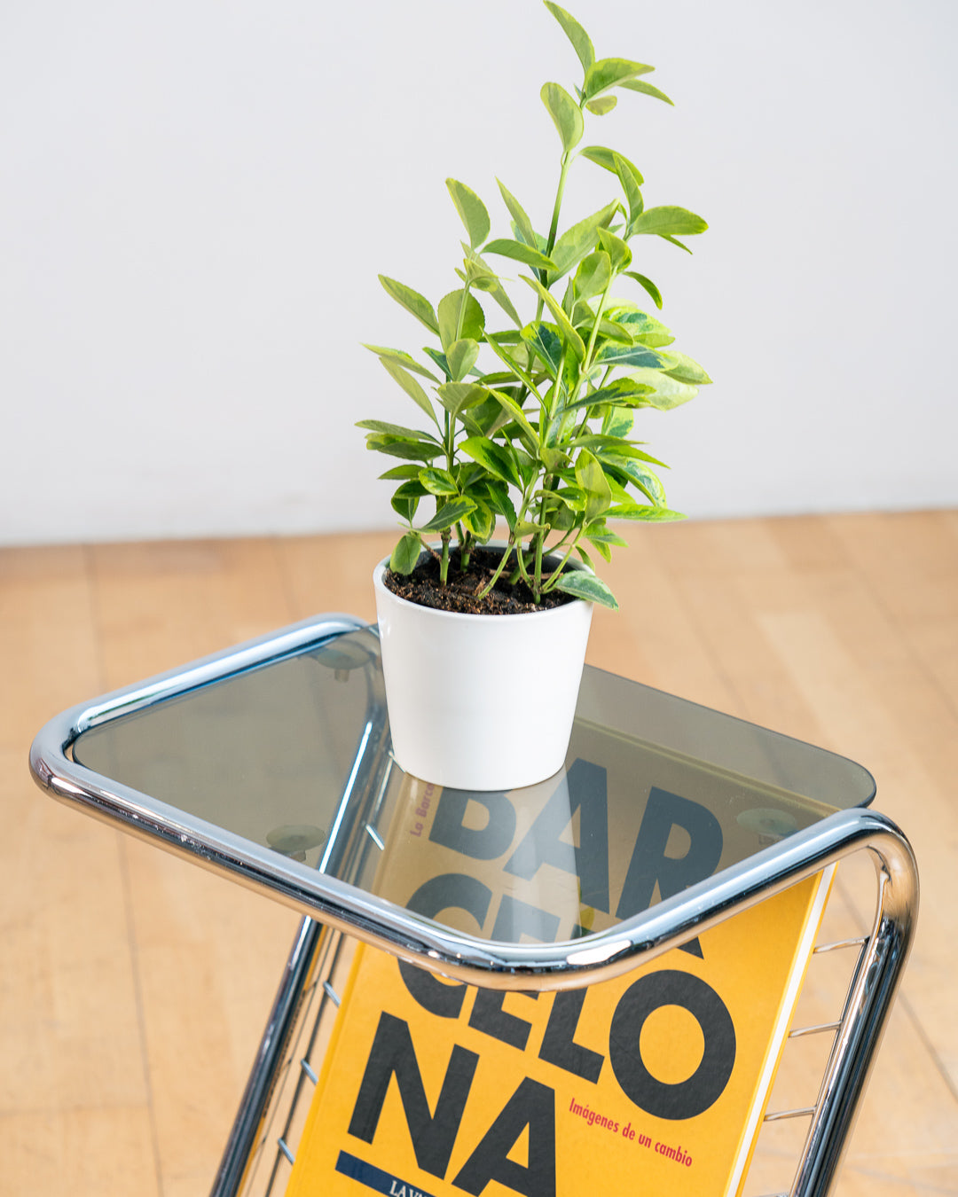 Vintage 1970s chrome side table with smoked glass top, black melamine shelf and integrated magazine rack. Vecino Shop