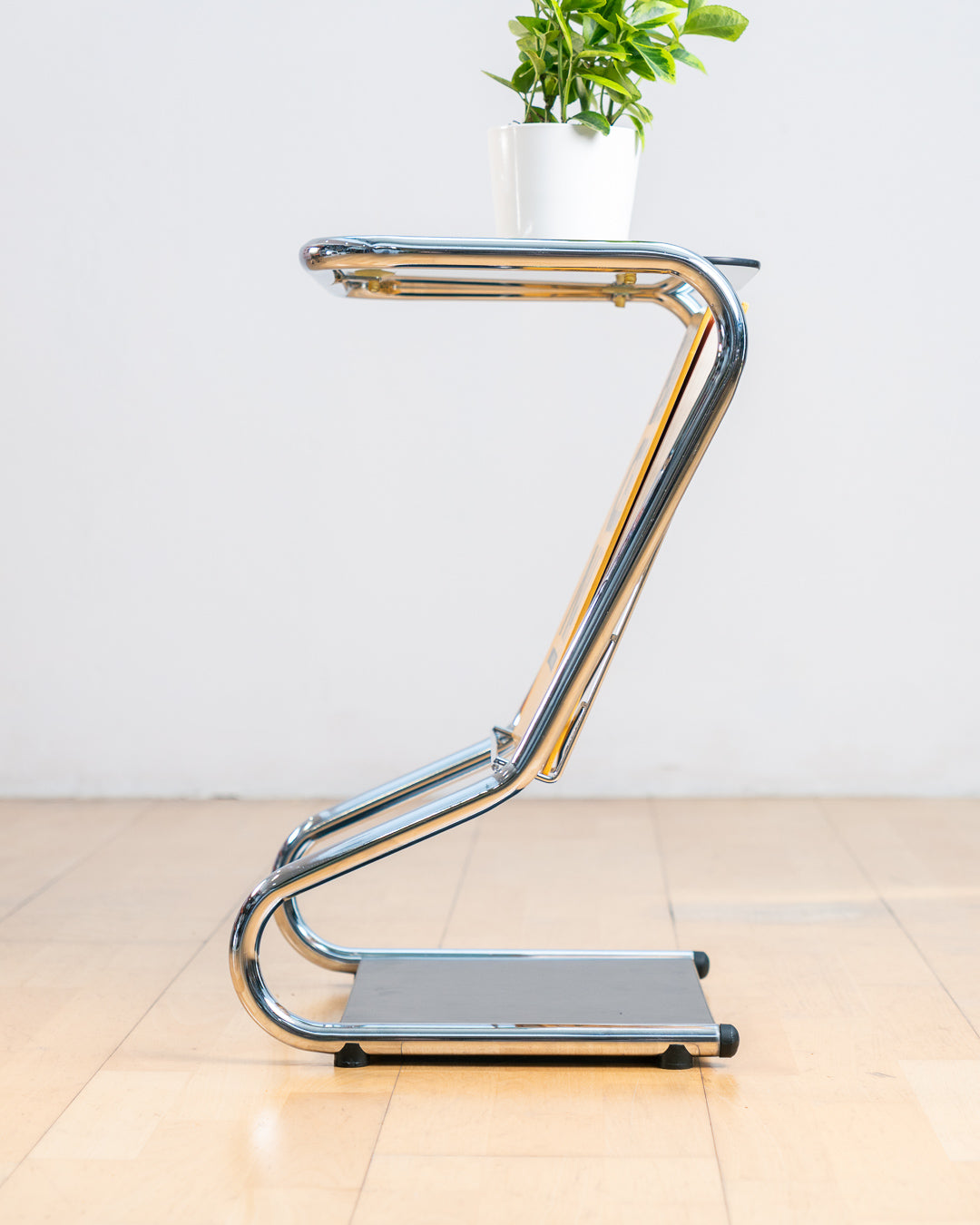 Vintage 1970s chrome side table with smoked glass top, black melamine shelf and integrated magazine rack. Vecino Shop