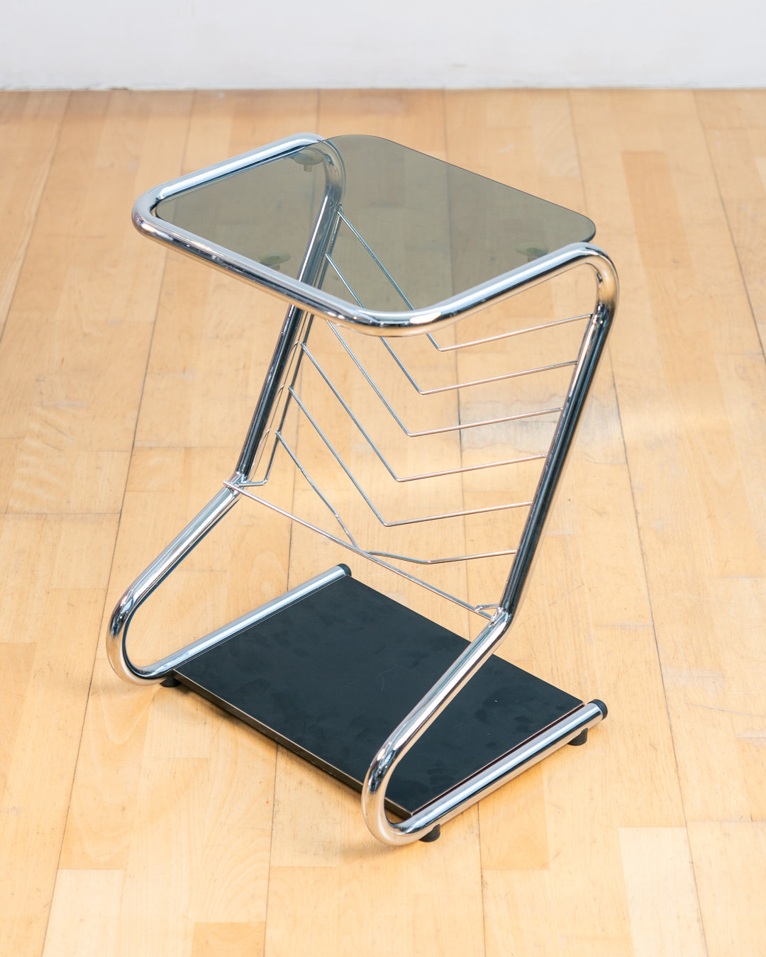 Vintage 1970s chrome side table with smoked glass top, black melamine shelf and integrated magazine rack. Vecino Shop