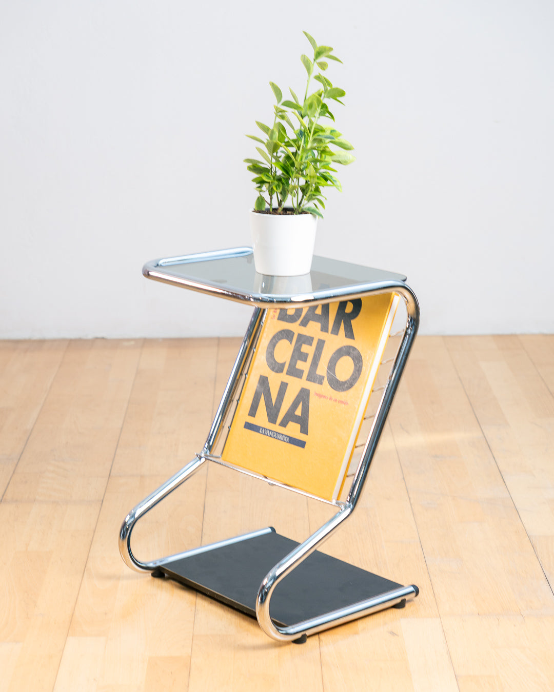 Vintage 1970s chrome side table with smoked glass top, black melamine shelf and integrated magazine rack. Vecino Shop