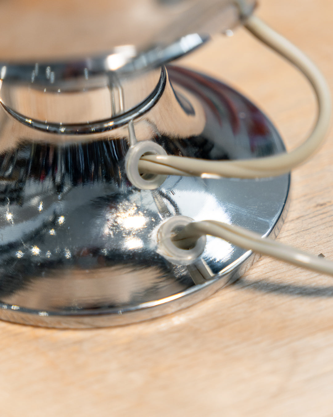 Vintage chrome eyeball table lamp from the 1970s with spherical shade and chrome-dipped bulb. Vecino Shop