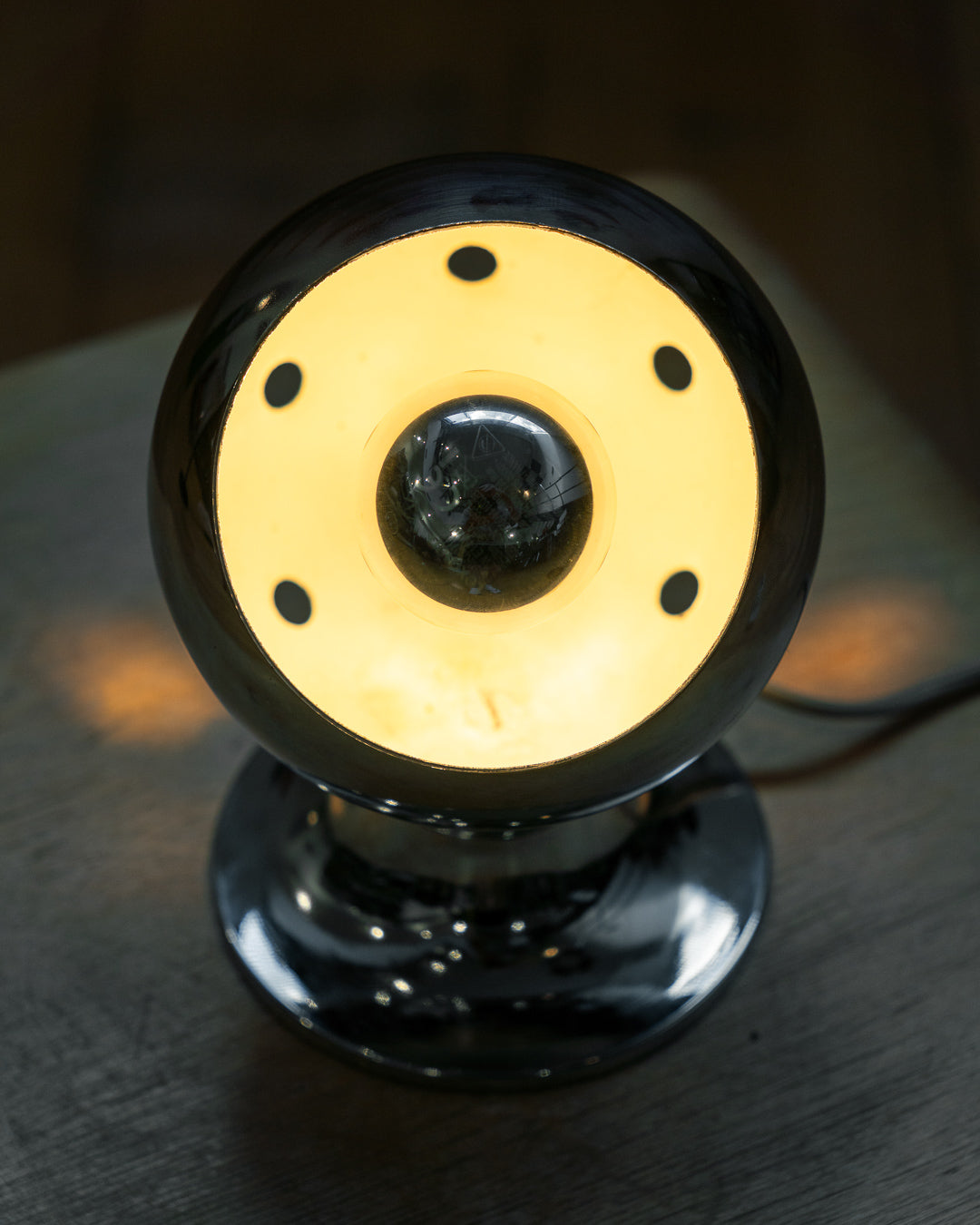 Vintage chrome eyeball table lamp from the 1970s with spherical shade and chrome-dipped bulb. Vecino Shop