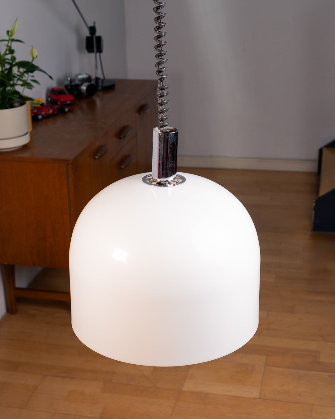 Vintage 1970s white acrylic dome extendable pendant lamp with chrome accents and adjustable coil, Space Age design. Vecino Shop