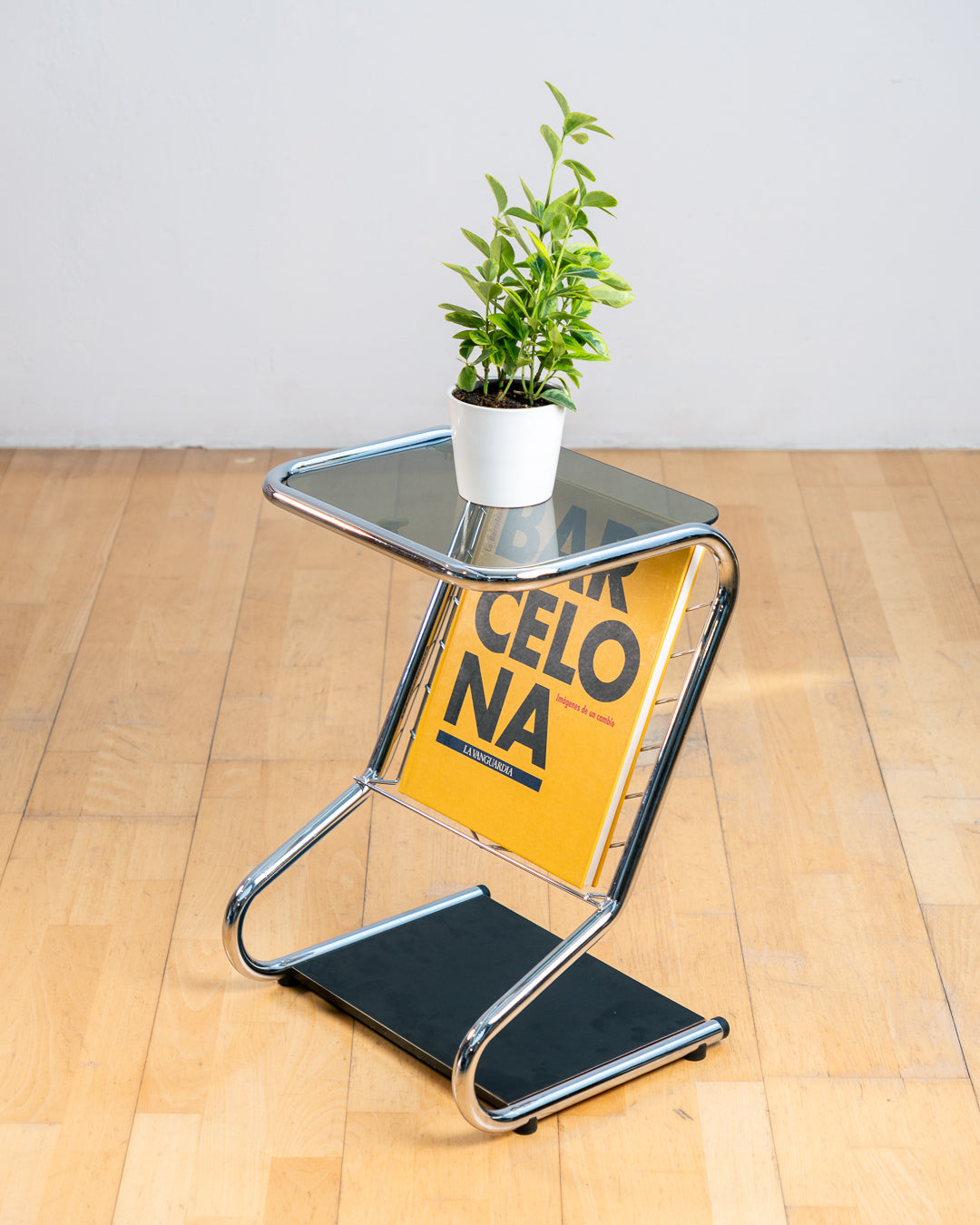Vintage 1970s chrome side table with smoked glass top, black melamine shelf and integrated magazine rack. Vecino Shop