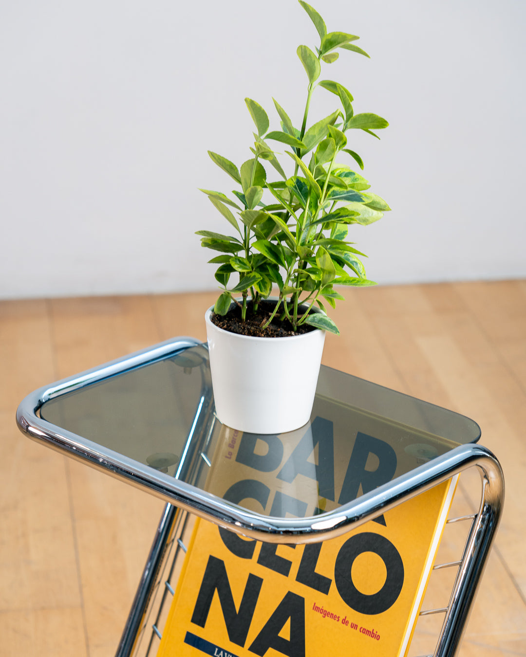 Vintage 1970s chrome side table with smoked glass top, black melamine shelf and integrated magazine rack. Vecino Shop