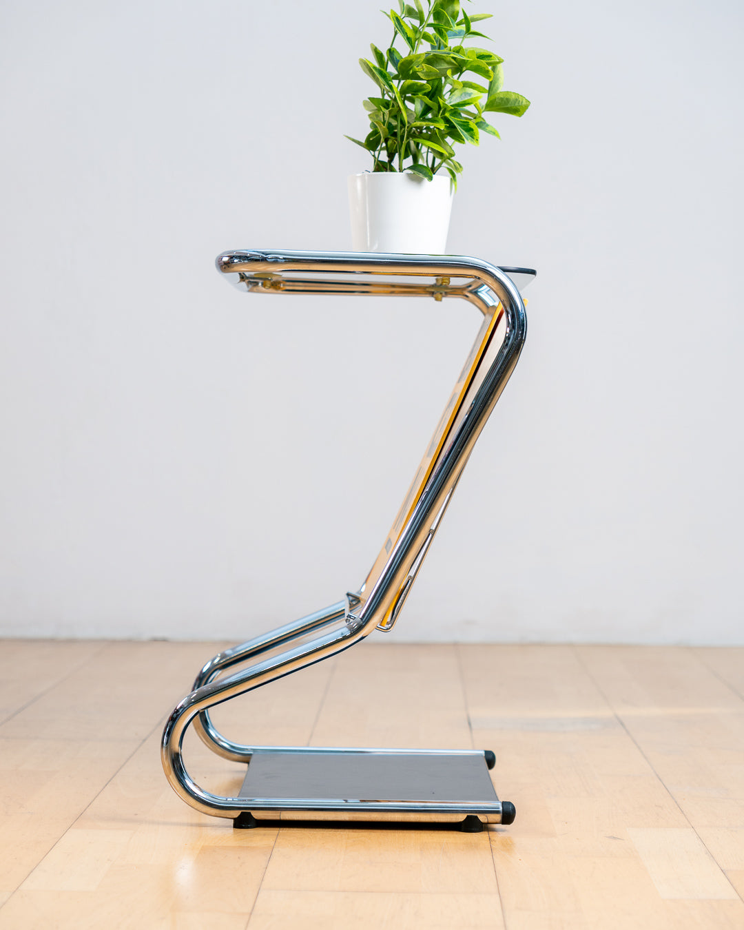 Vintage 1970s chrome side table with smoked glass top, black melamine shelf and integrated magazine rack. Vecino Shop