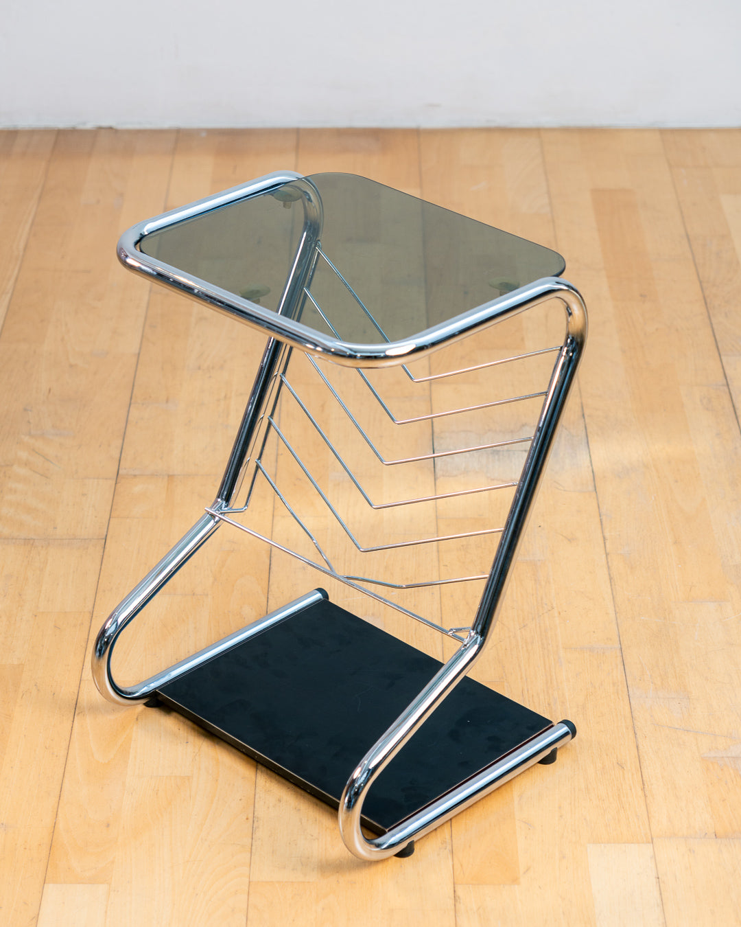 Vintage 1970s chrome side table with smoked glass top, black melamine shelf and integrated magazine rack. Vecino Shop