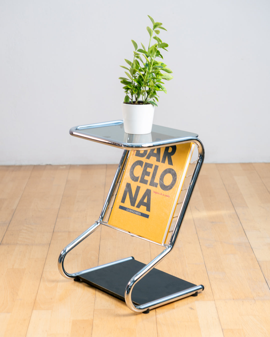 Vintage 1970s chrome side table with smoked glass top, black melamine shelf and integrated magazine rack. Vecino Shop