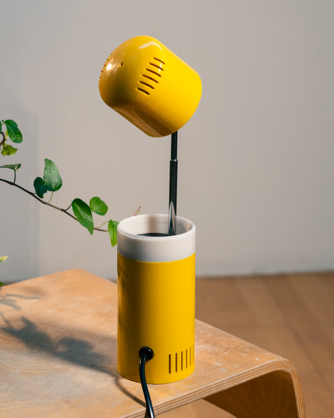 Vintage yellow folding pill-shaped table lamp from the 1970s with translucent glowing detail - night light ambient. Vecino Shop