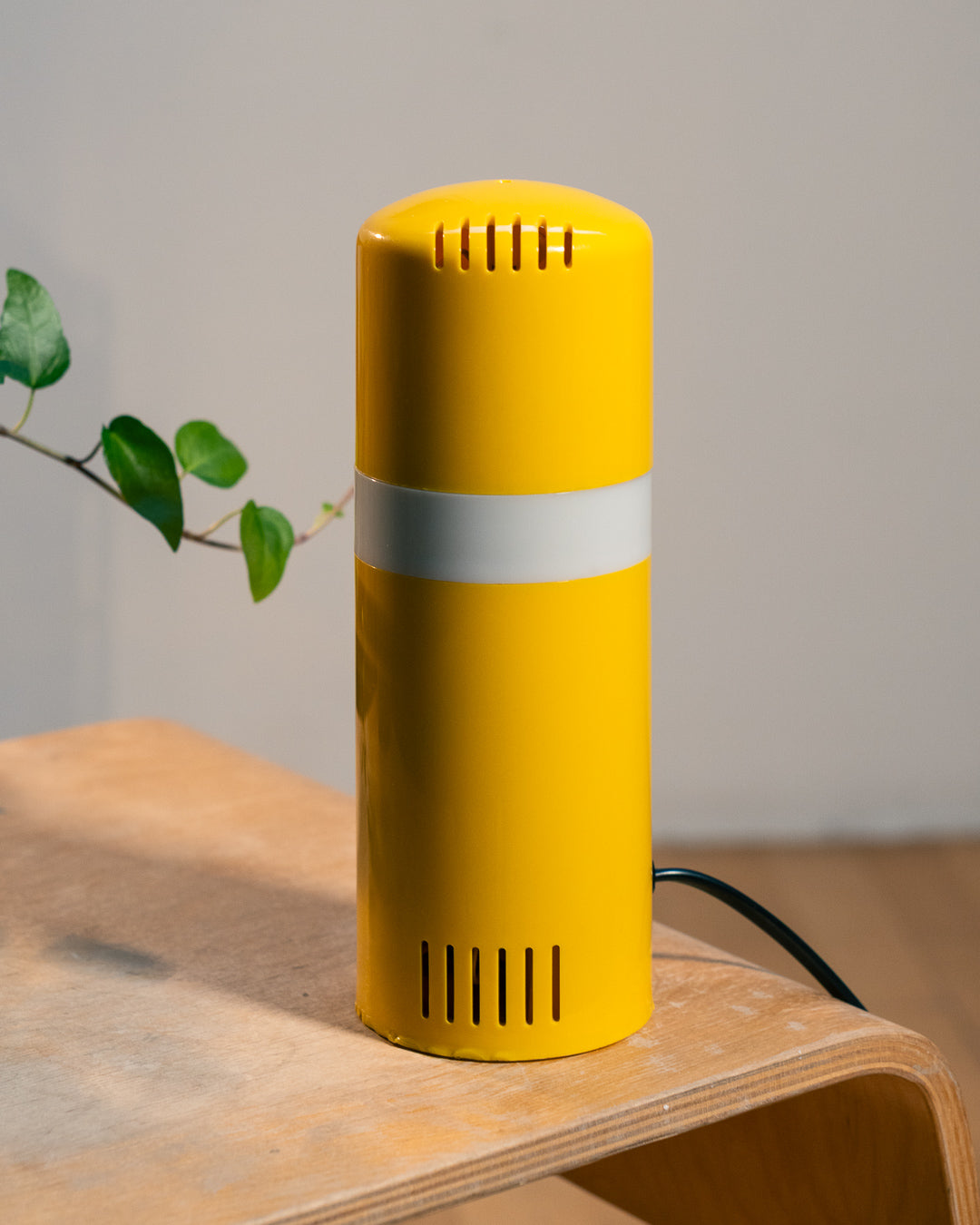 Vintage yellow folding pill-shaped table lamp from the 1970s with translucent glowing detail - night light ambient. Vecino Shop