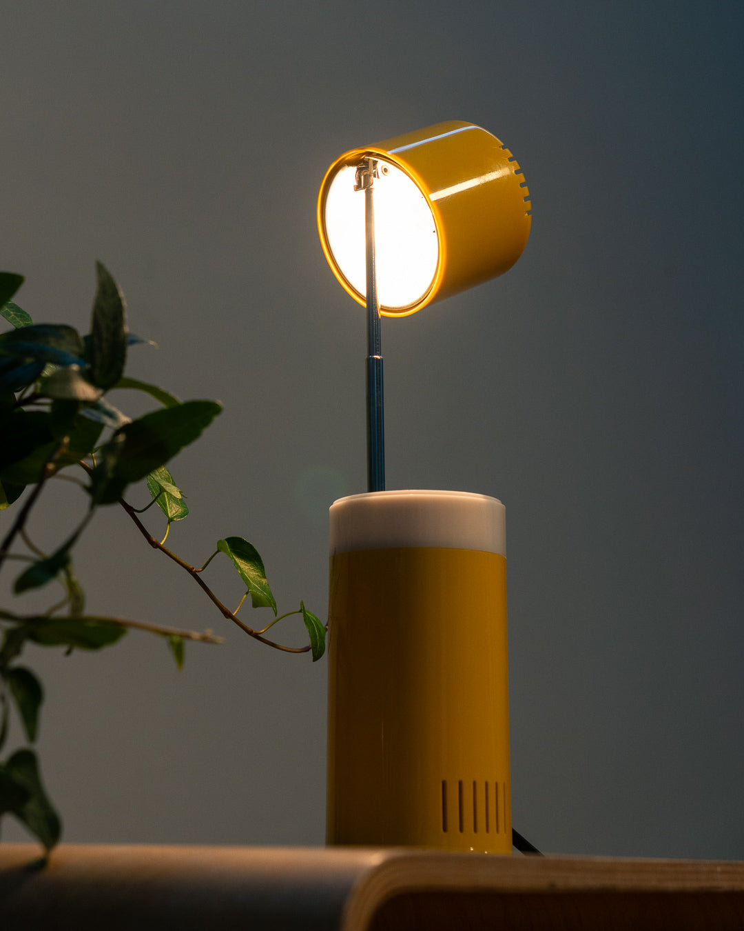 Vintage yellow folding pill-shaped table lamp from the 1970s with translucent glowing detail - night light ambient. Vecino Shop