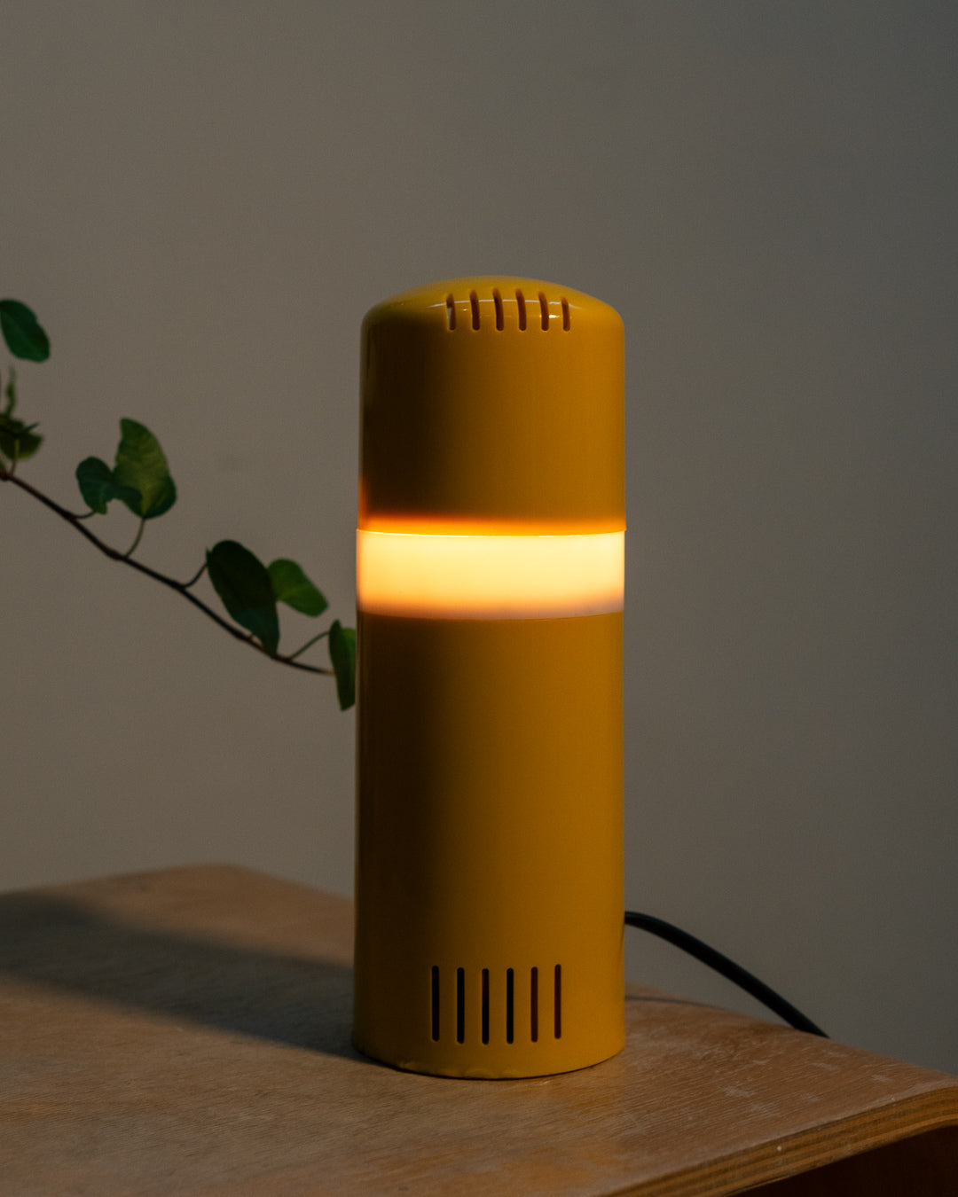 Vintage yellow folding pill-shaped table lamp from the 1970s with translucent glowing detail - night light ambient. Vecino Shop