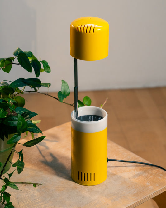 Vintage yellow folding pill-shaped table lamp from the 1970s with translucent glowing detail - night light ambient. Vecino Shop