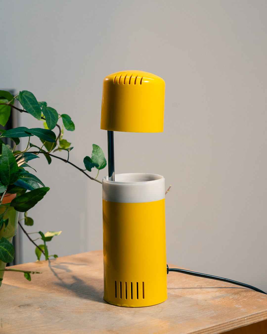 Vintage yellow folding pill-shaped table lamp from the 1970s with translucent glowing detail - night light ambient. Vecino Shop