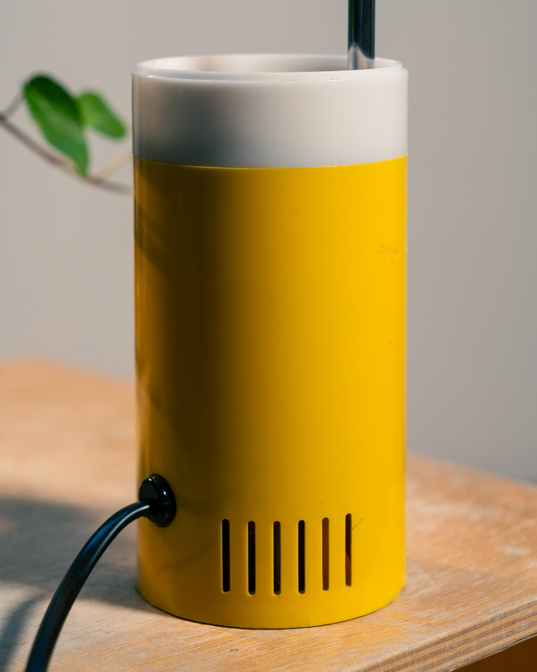 Vintage yellow folding pill-shaped table lamp from the 1970s with translucent glowing detail - night light ambient. Vecino Shop