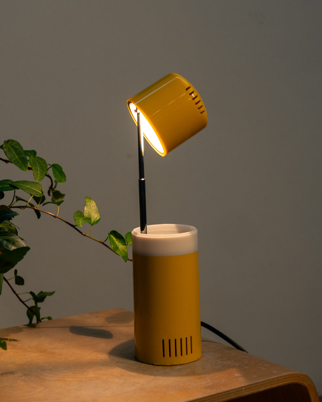 Vintage yellow folding pill-shaped table lamp from the 1970s with translucent glowing detail - night light ambient. Vecino Shop