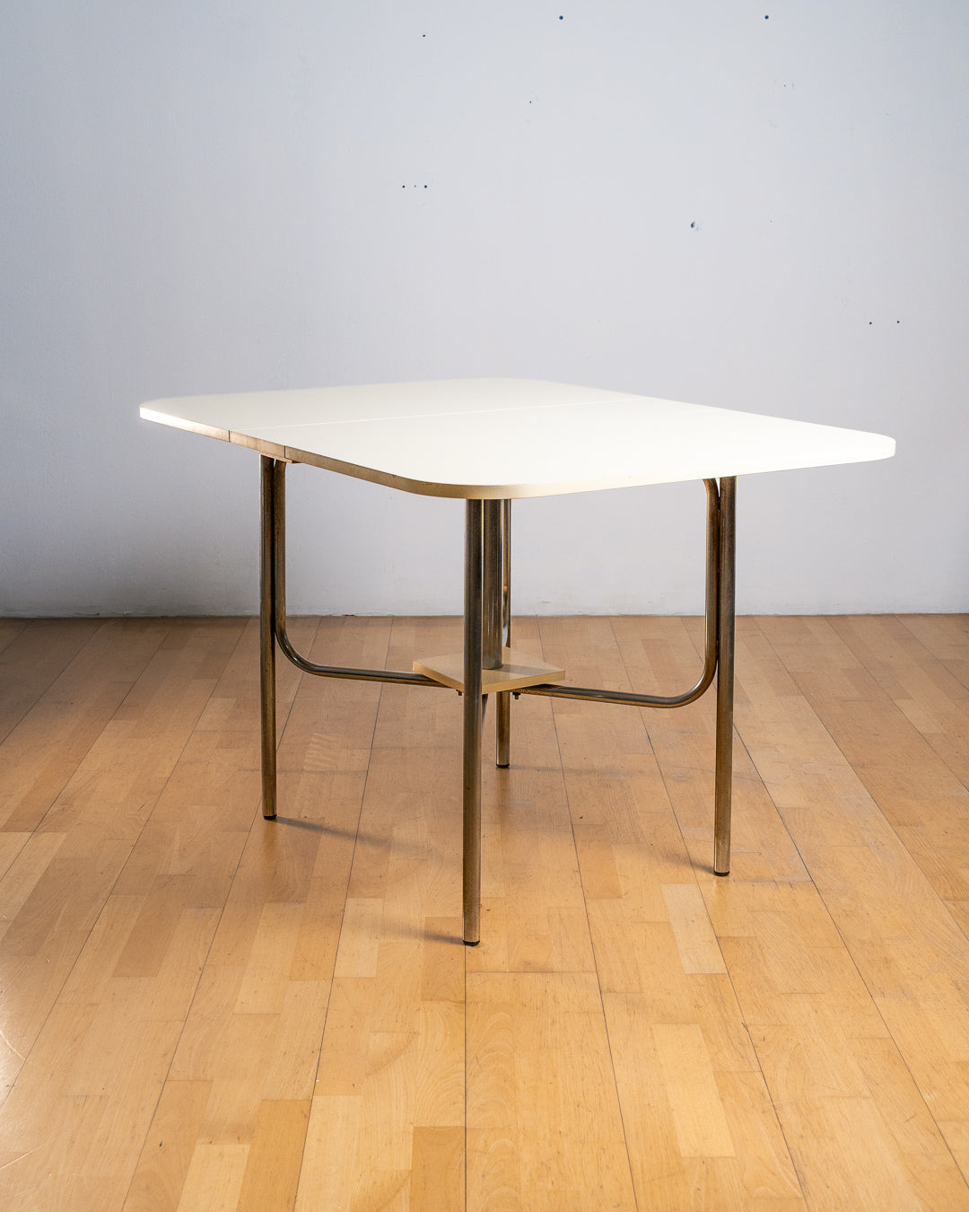 Vintage 1980s rectangular off-white Formica folding dining table with chrome tubular legs and rounded corners. Space Age design, Vecino Shop.