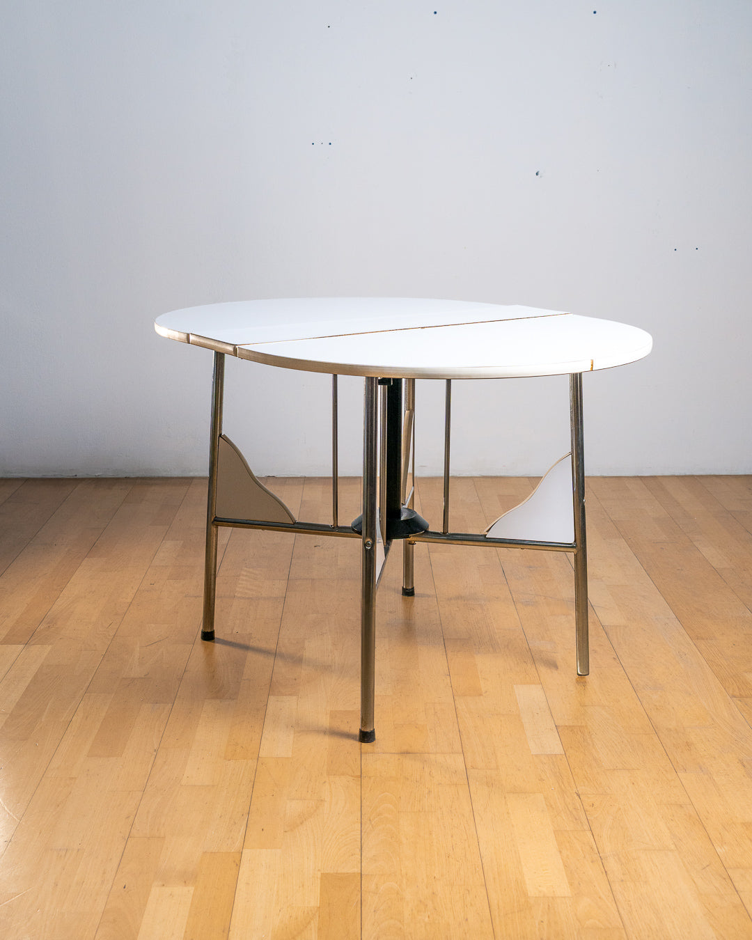 Vintage 1980s folding dining table with chrome tubular legs and a custom made Formica tabletop. Paneled leg inserts and a functional Space Age design. Vecino Shop