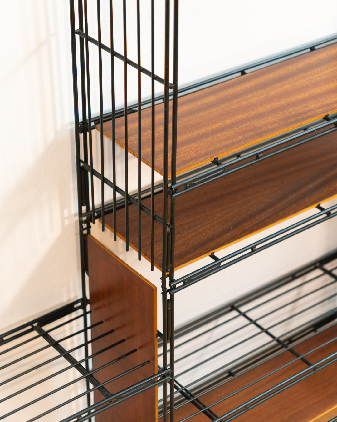 Vintage 1960s teak wood and matte black Multistrux modular string shelving system with twelve shelves, restored vintage design piece. Vecino Shop