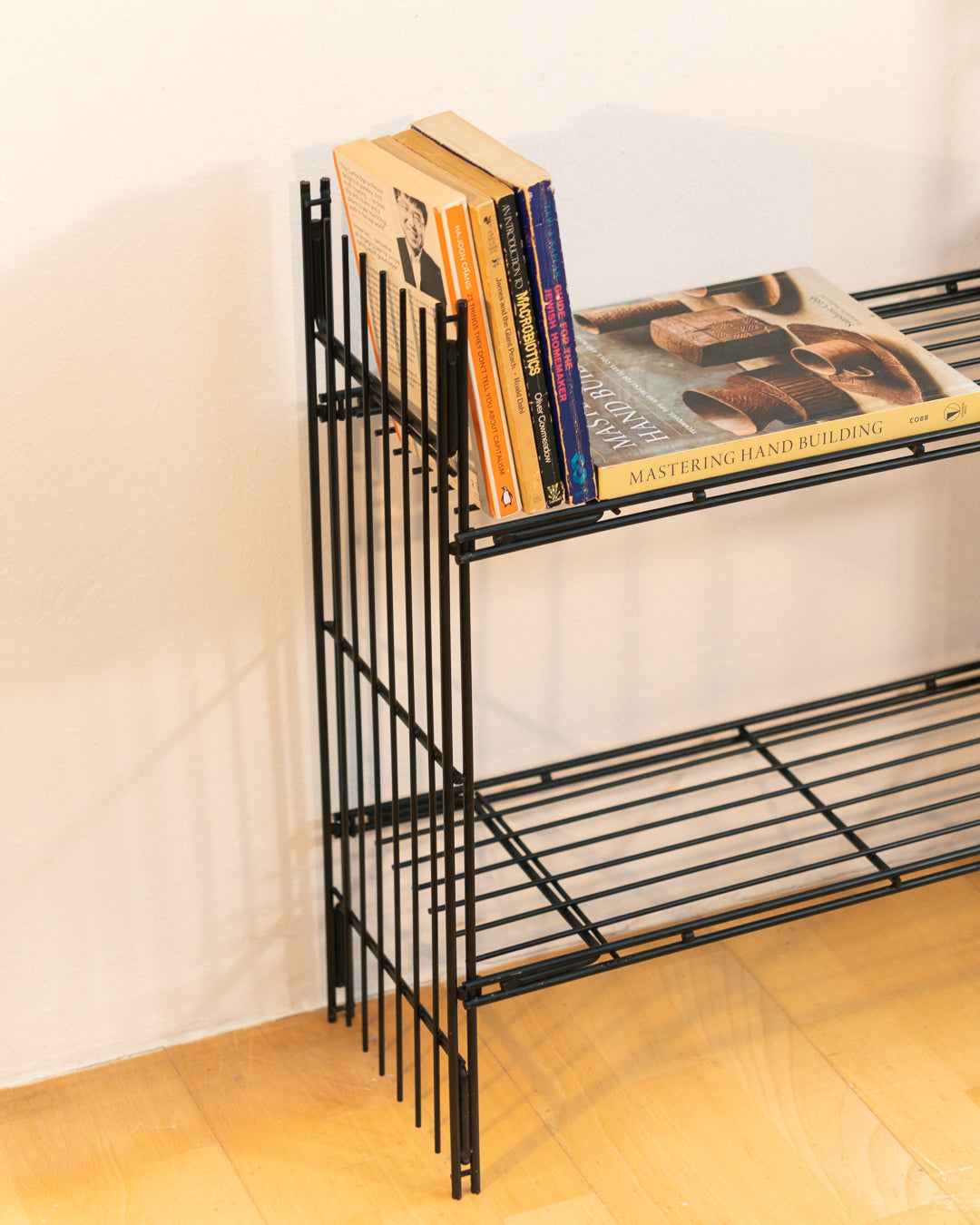 Vintage 1960s teak wood and matte black Multistrux modular string shelving system with twelve shelves, restored vintage design piece. Vecino Shop