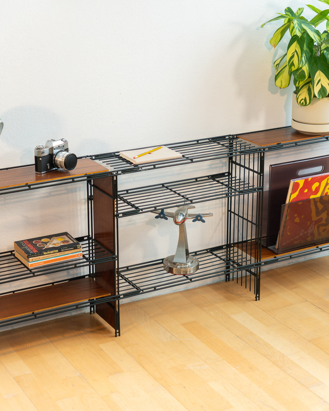 Vintage 1960s teak wood and matte black Multistrux modular string shelving system with twelve shelves, restored vintage design piece. Vecino Shop