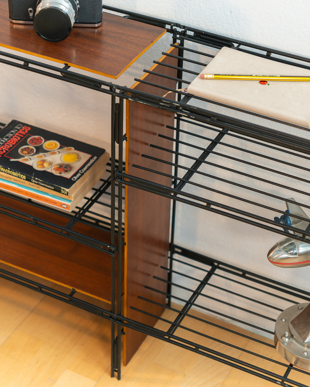 Vintage 1960s teak wood and matte black Multistrux modular string shelving system with twelve shelves, restored vintage design piece. Vecino Shop