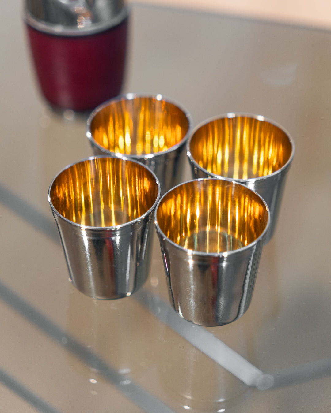 Vintage owl nesting shot glass set from West Germany with chrome head, amber eyes, and leather body. Vecino Shop