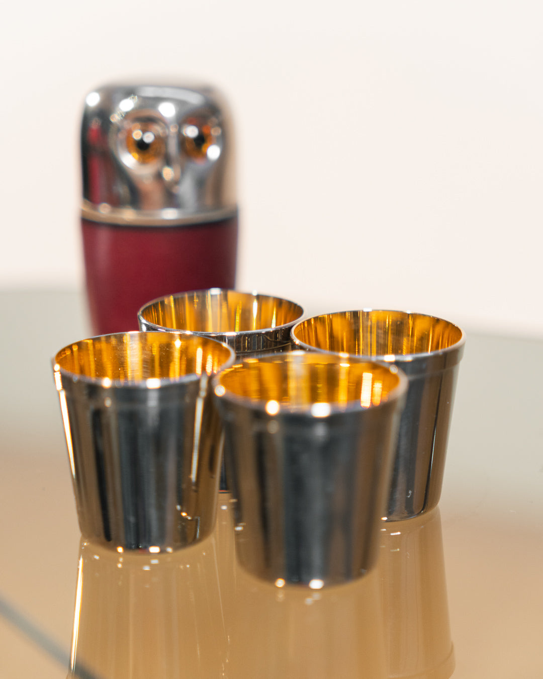Vintage owl nesting shot glass set from West Germany with chrome head, amber eyes, and leather body. Vecino Shop