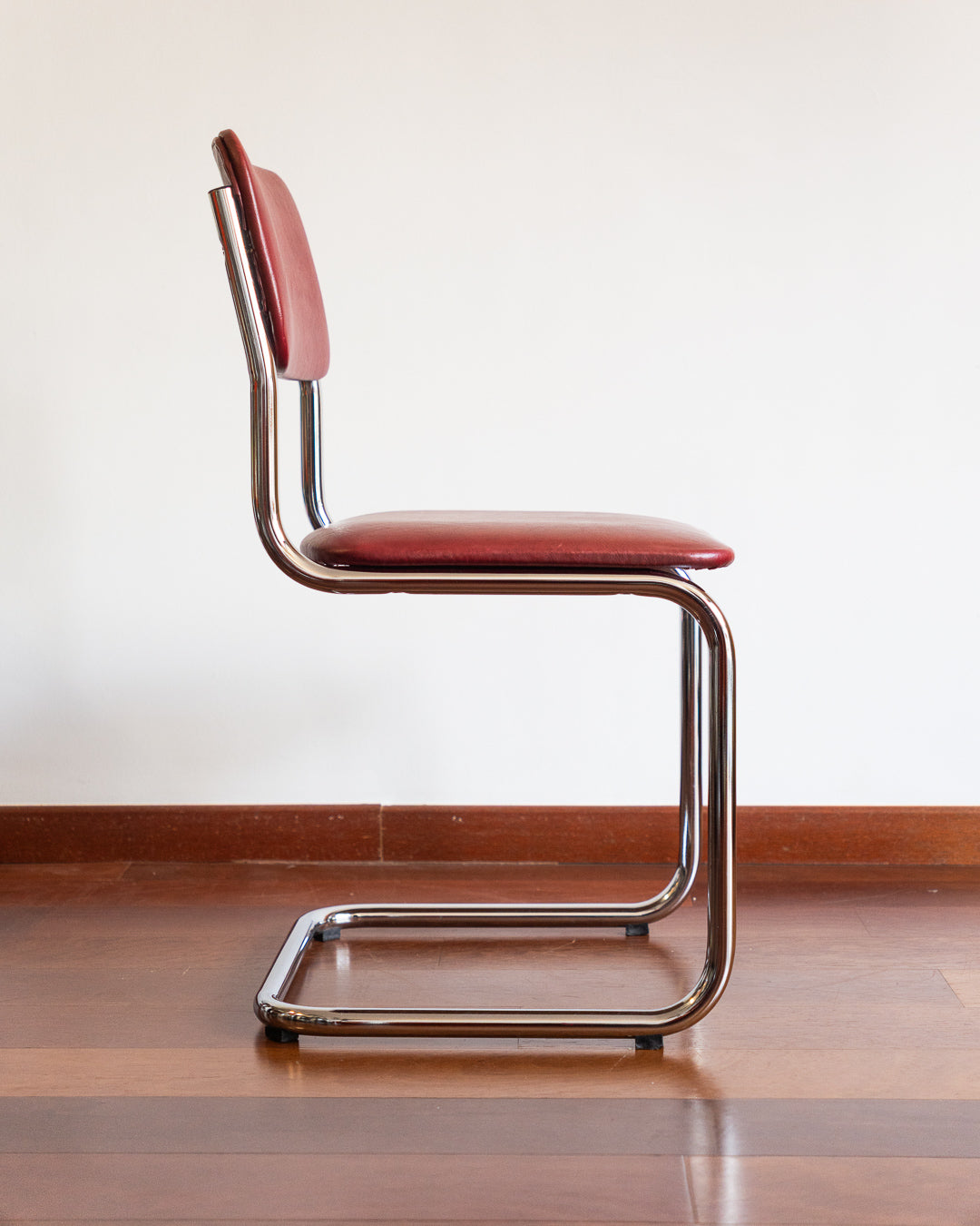 Mid-century chrome cantilever chair with red vinyl upholstery