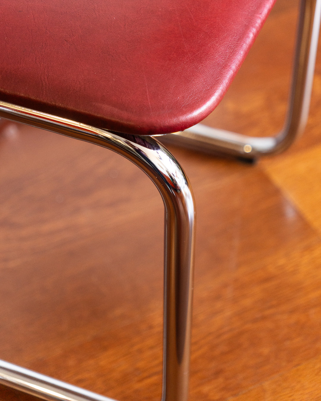 Mid-century chrome cantilever chair with red vinyl upholstery