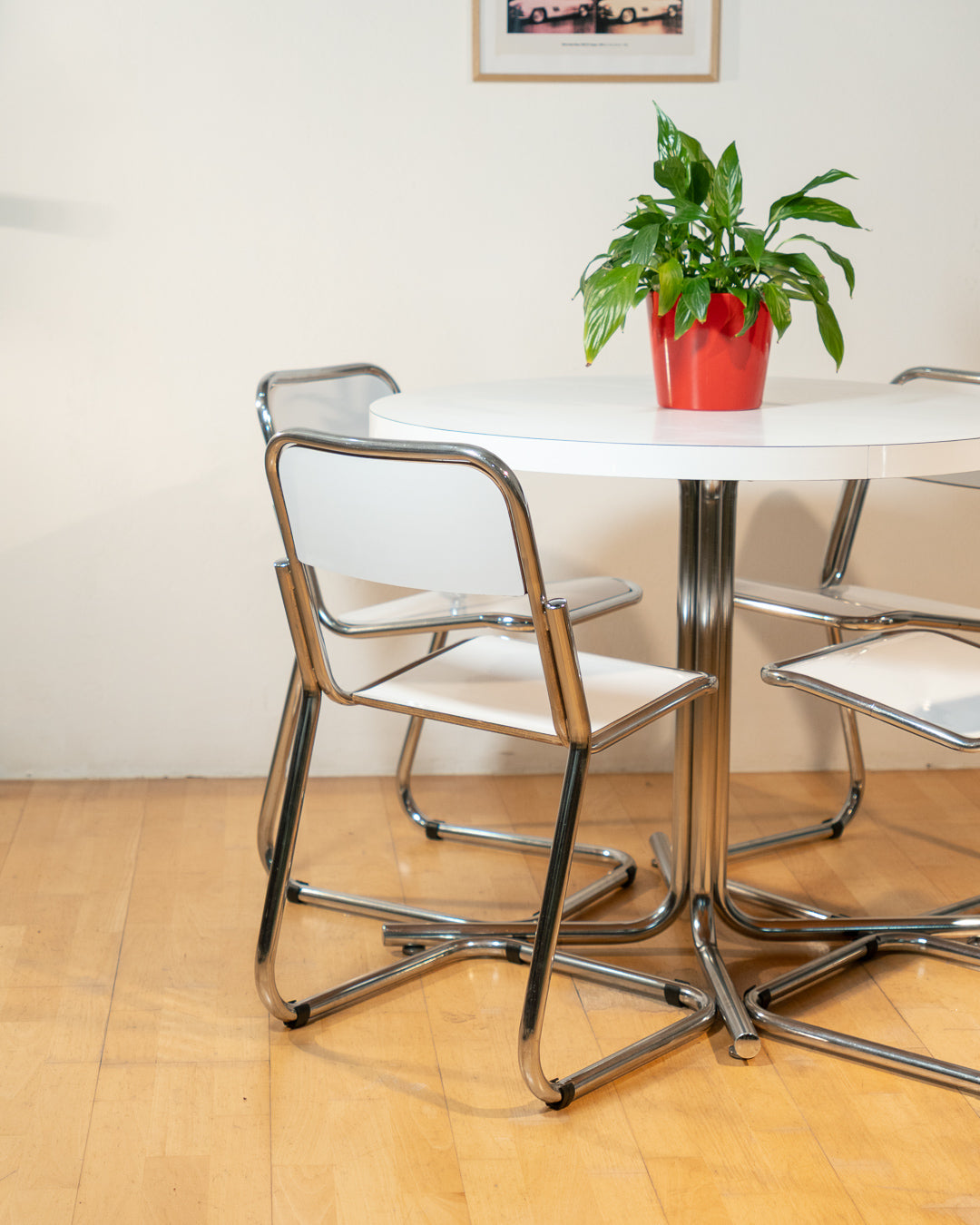 Vintage 1970s Bauhaus dining set with white formica cantilever chairs and chrome pedestal dining table - Mid Century Modern. Vecino Shop