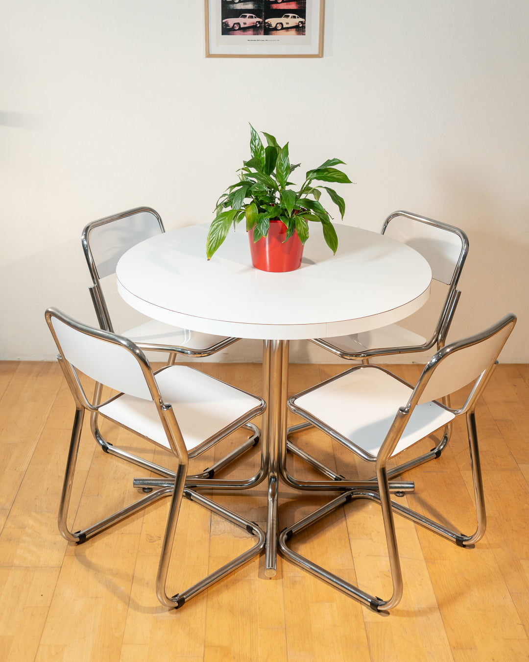 Vintage 1970s Bauhaus dining set with white formica cantilever chairs and chrome pedestal dining table - Mid Century Modern. Vecino Shop
