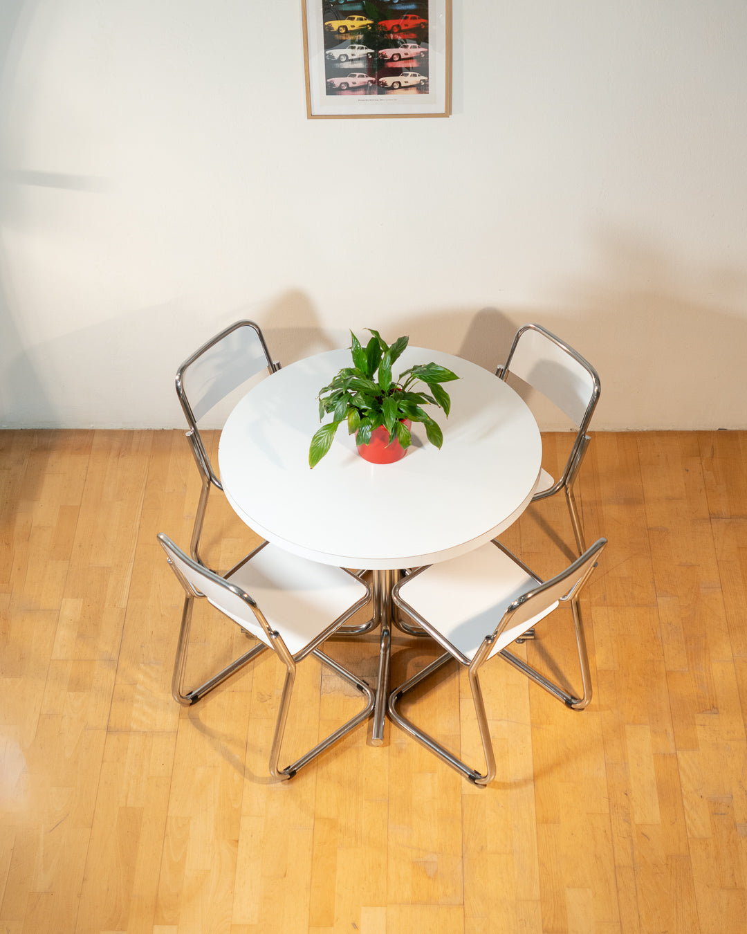 Vintage 1970s Bauhaus dining set with white formica cantilever chairs and chrome pedestal dining table - Mid Century Modern. Vecino Shop