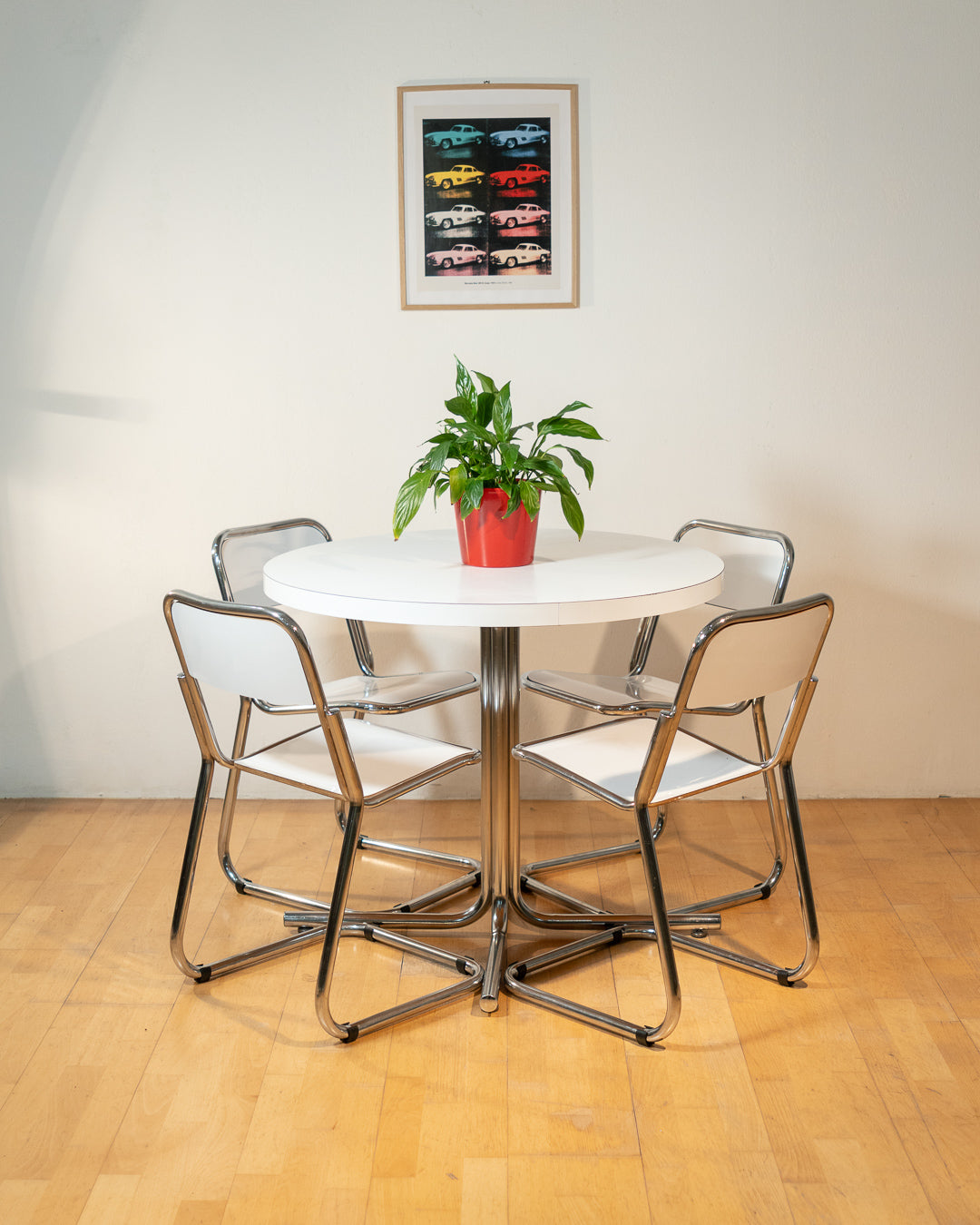 Vintage 1970s Bauhaus dining set with white formica cantilever chairs and chrome pedestal dining table - Mid Century Modern. Vecino Shop