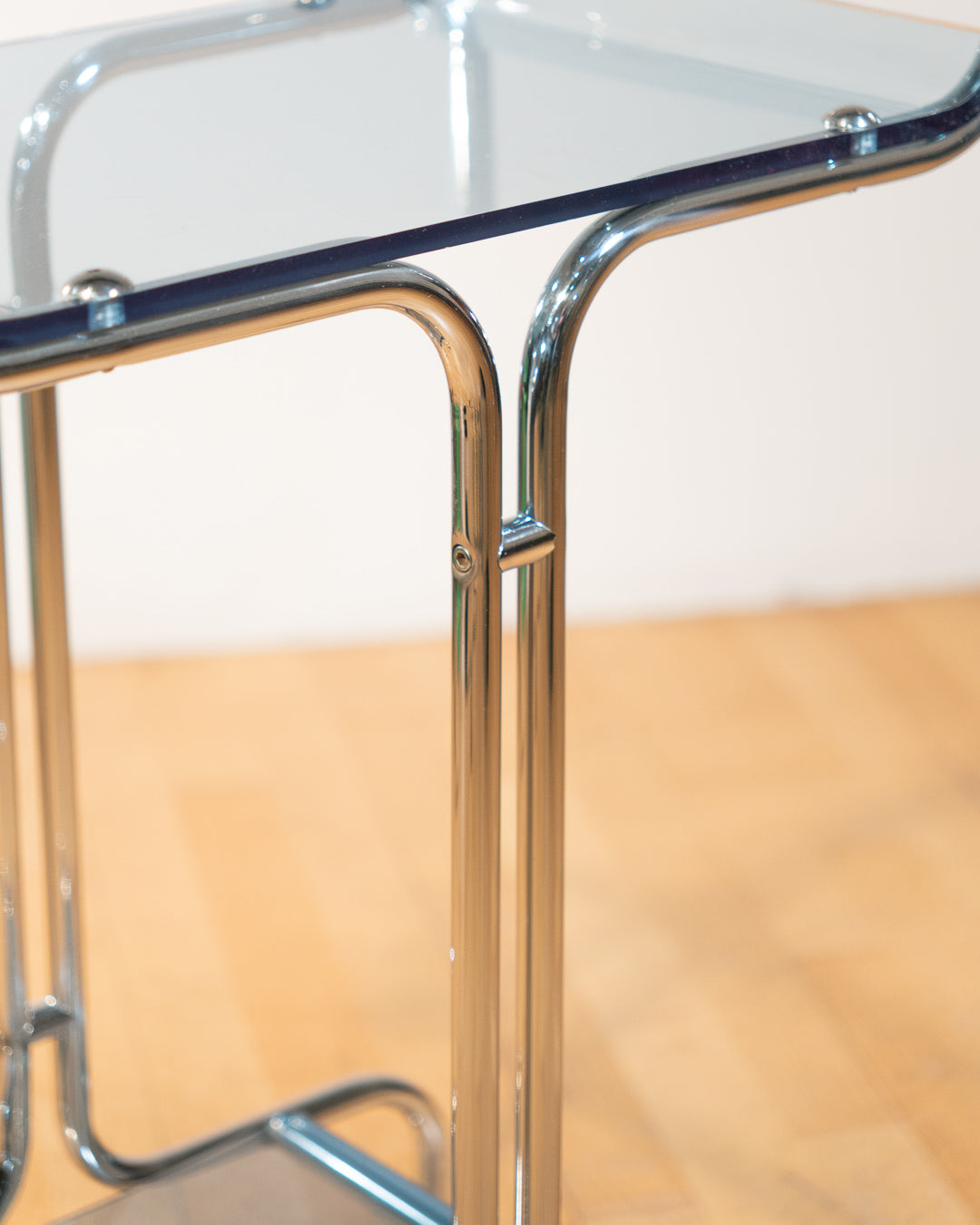 1970s chrome rolling side table with baby blue acrylic shelves, two-level mid-century modern design. Vecino Shop