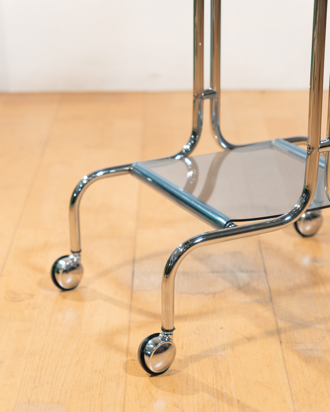 1970s chrome rolling side table with baby blue acrylic shelves, two-level mid-century modern design. Vecino Shop