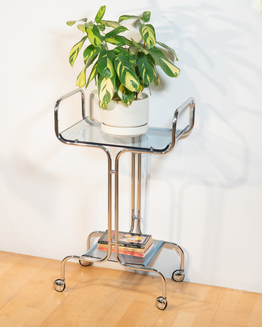 1970s chrome rolling side table with baby blue acrylic shelves, two-level mid-century modern design. Vecino Shop